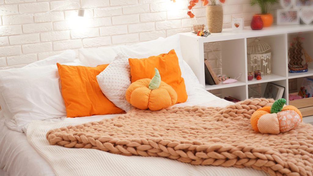 A chunky knit blanket is the perfect way to add a pop of fall color to your bed!